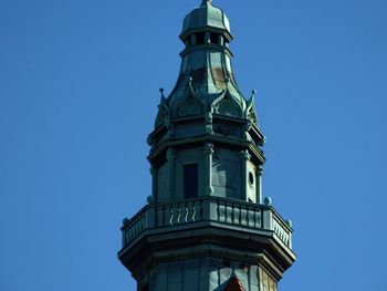 Low angle view of clock tower against clear blue sky