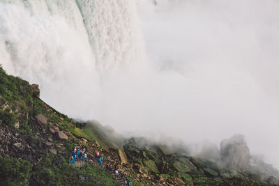 Scenic view of waterfall against sky