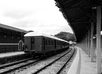 Train at railroad station against sky