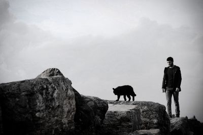 Man standing on rock against mountain