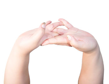 Close-up of hands over white background