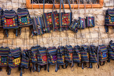 Multi colored bags hanging on wall