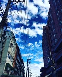 Low angle view of building against cloudy sky