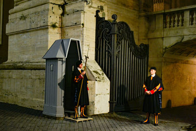 Full length of woman standing by building