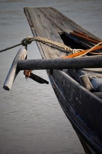 Close-up of boat moored in lake against sky