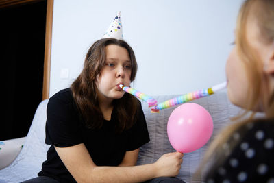 Children have fun playing, blowing up colorful balloons, at a birthday party