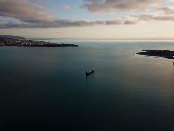 Scenic view of sea and ship against sky