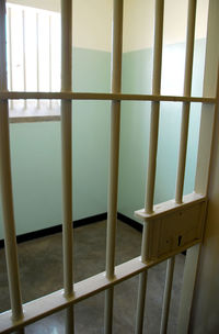 Close-up of railing by window in building