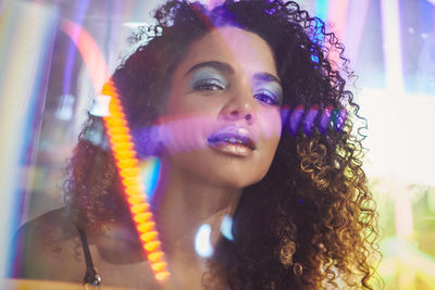 Portrait of beautiful young woman with curly hair