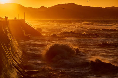 Scenic view of sea against sky during sunrise