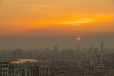 Cityscape against sky during sunset