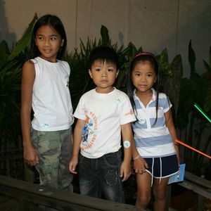 Portrait of siblings standing outdoors