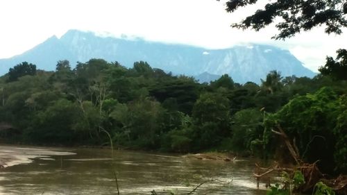 Scenic view of river in front of mountains