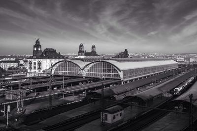 Railroad station in city against sky