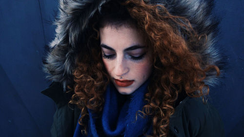 Close-up of young woman in fur coat