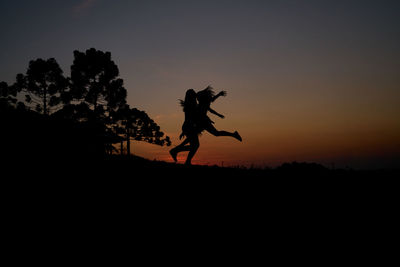 Silhouette statue against clear sky during sunset