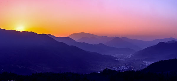 Scenic view of silhouette mountains against sky at sunset