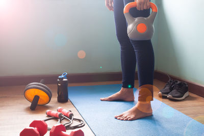 Low section of woman playing with ball