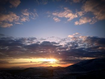 Scenic view of mountains against sky at sunset