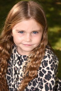 Close-up portrait of girl wearing leopard print dress