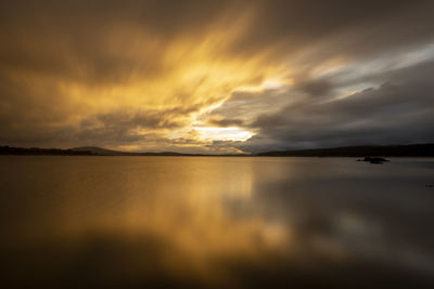 Scenic view of sea against dramatic sky