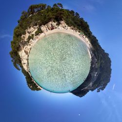 Digital composite image of trees and blue sky