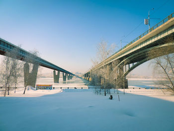 Bridge against clear blue sky during winter