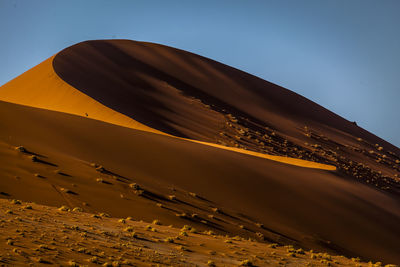 Low angle view of desert against clear sky