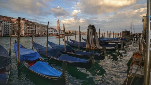 Sailboats moored in canal