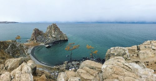 Scenic view of rock formations and baikal lake against sky