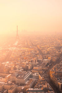 Aerial view of city district with residential buildings and eiffel tower on champ de mars in haze in paris
