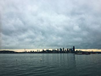 Panoramic view of sea and cityscape against sky