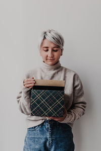 Mid adult woman standing against white background