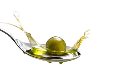 Close-up of wineglass against white background