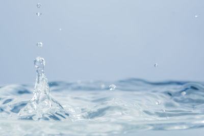 Close-up of water splashing against white background