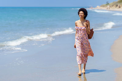 Young woman standing at beach