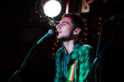 Young man singing during concert