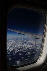 Cropped image of airplane wing over landscape