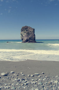 Scenic view of beach against clear sky