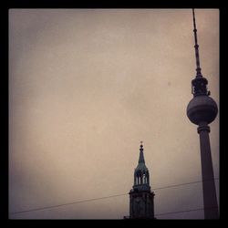 Low angle view of communications tower against sky