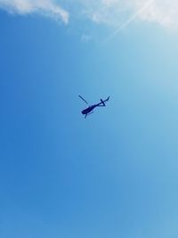 Low angle view of helicopter flying in sky