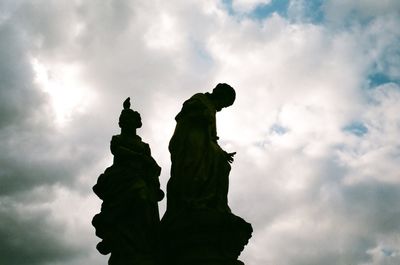 Low angle view of statue against cloudy sky