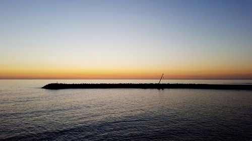 Scenic view of calm sea at sunset