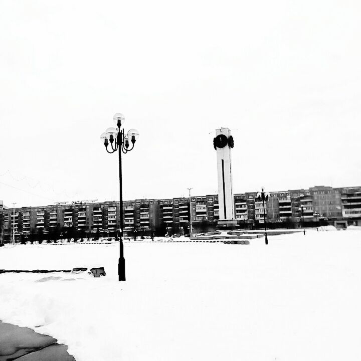 STREET LIGHT AGAINST SKY IN CITY