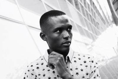 Young man looking away in city