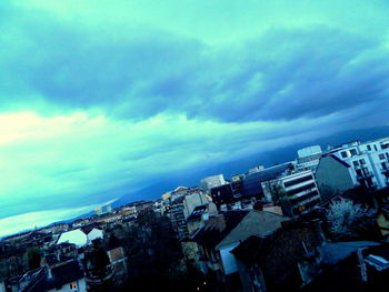 Buildings against cloudy sky