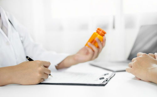 Midsection of doctor examining patient