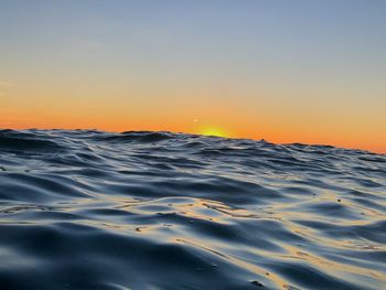 Scenic view of sea against clear sky during sunset