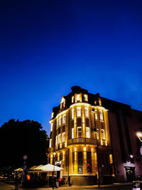 Illuminated building against sky at night