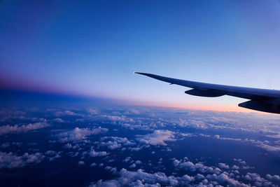 Aerial view of airplane flying in sky